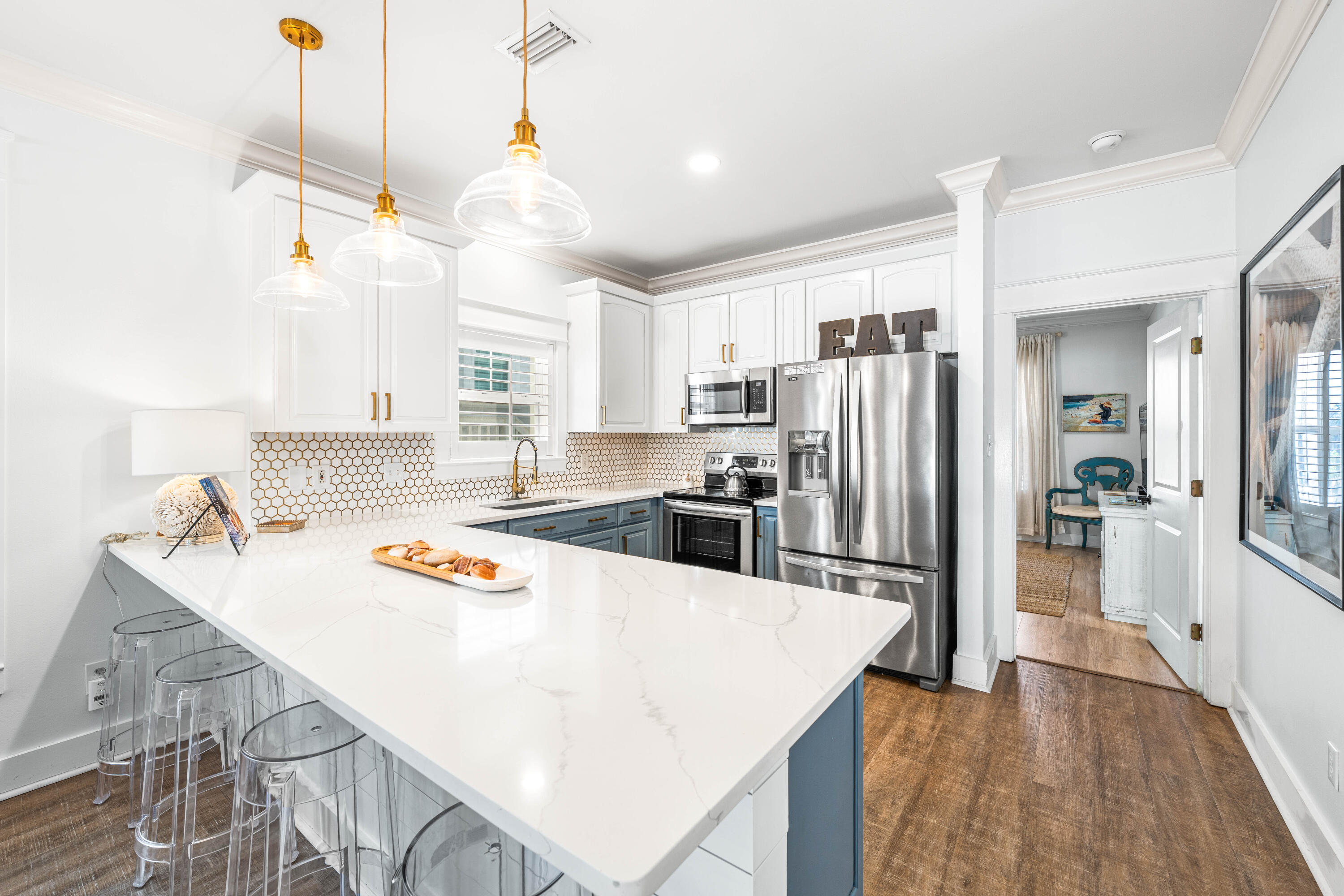 59 Endless Summer Way West Inlet Beach, FL 32461 - Photo 5 of 40 a kitchen with stainless steel appliances granite countertop a sink a stove a refrigerator and island with wooden floor