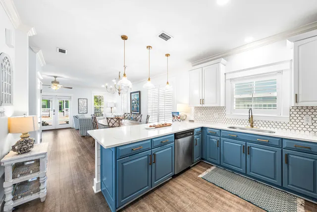 a large kitchen with kitchen island a sink stainless steel appliances and cabinets