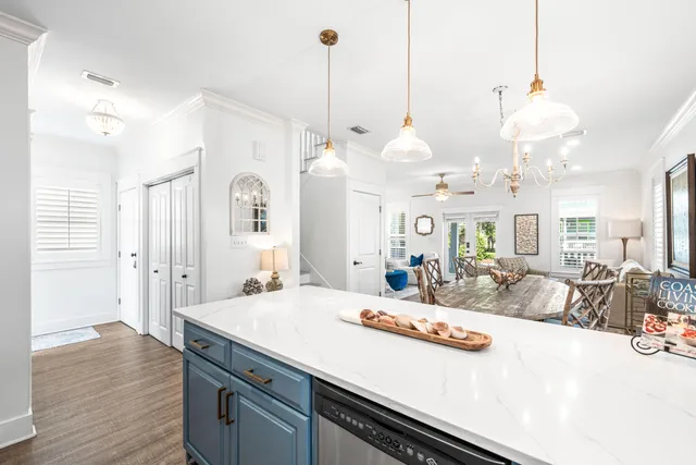 a large kitchen with kitchen island a stove a sink a center island and wooden floor