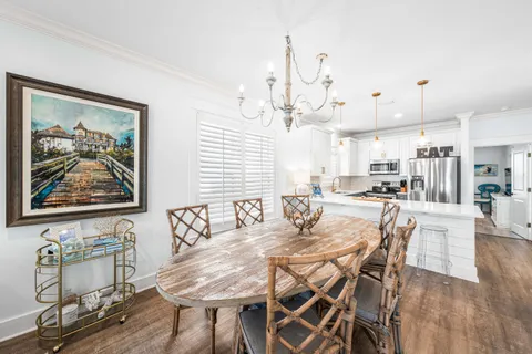 a view of a dining room with furniture wooden floor and a chandelier
