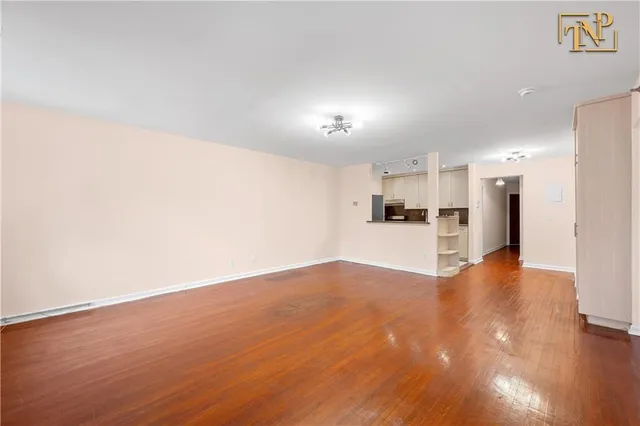 a view of a kitchen with a sink and a refrigerator
