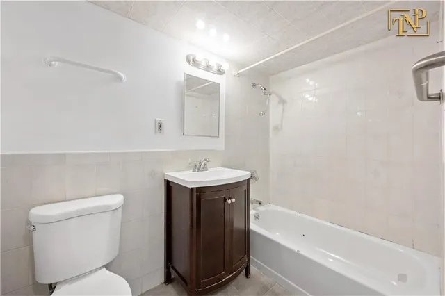 a bathroom with a sink a toilet and bathtub