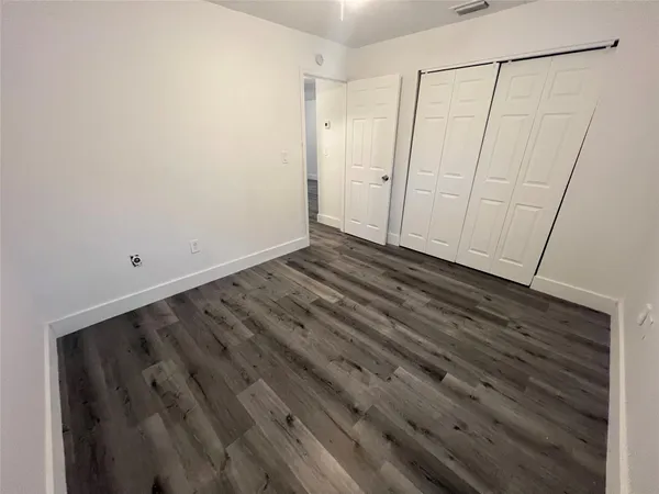 a view of room with wooden floor