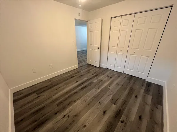 a view of a room with wooden floor