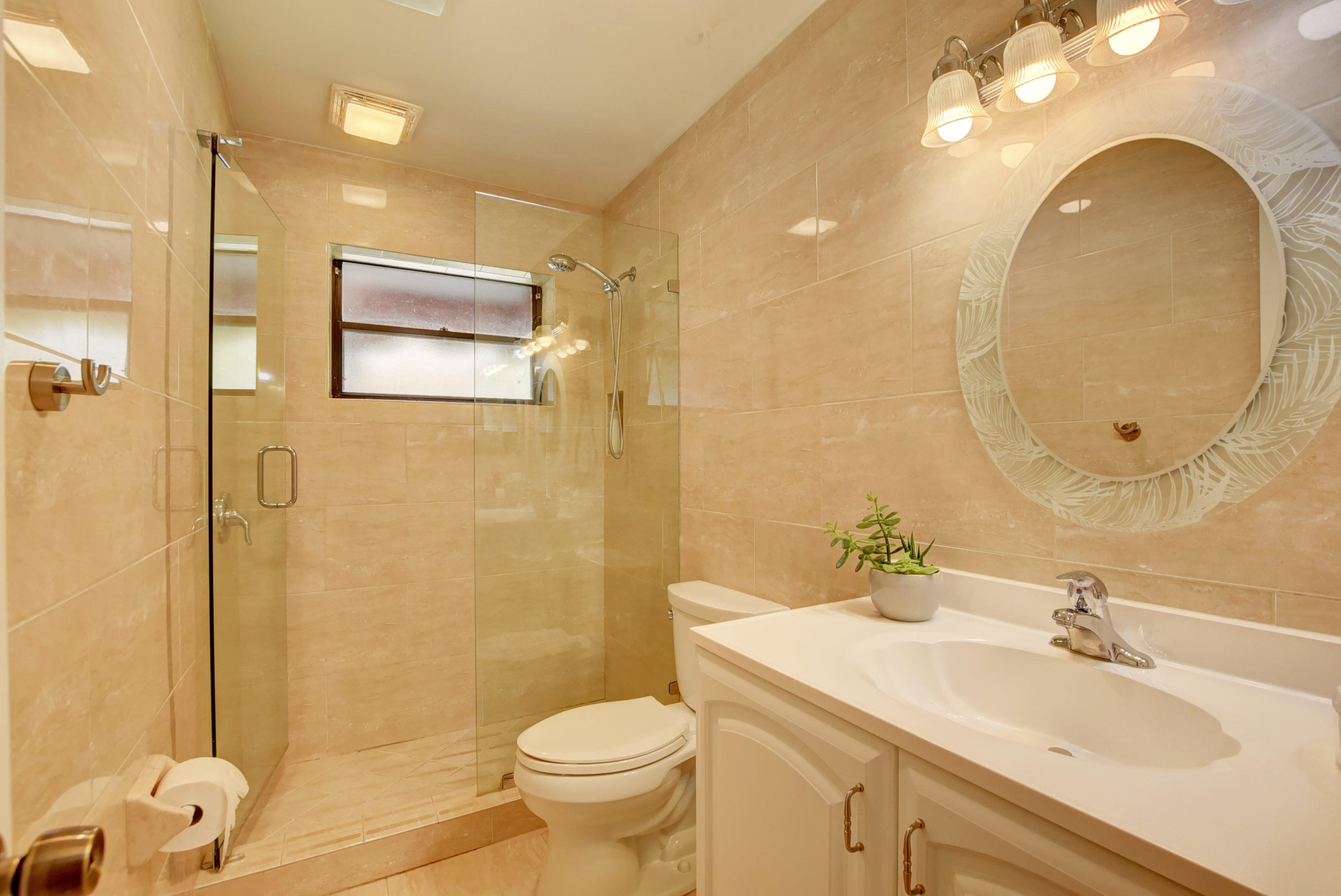 491 Northwest 72nd Street Boca Raton, FL 33487 - Photo 23 of 57 a bathroom with a sink a toilet and a mirror