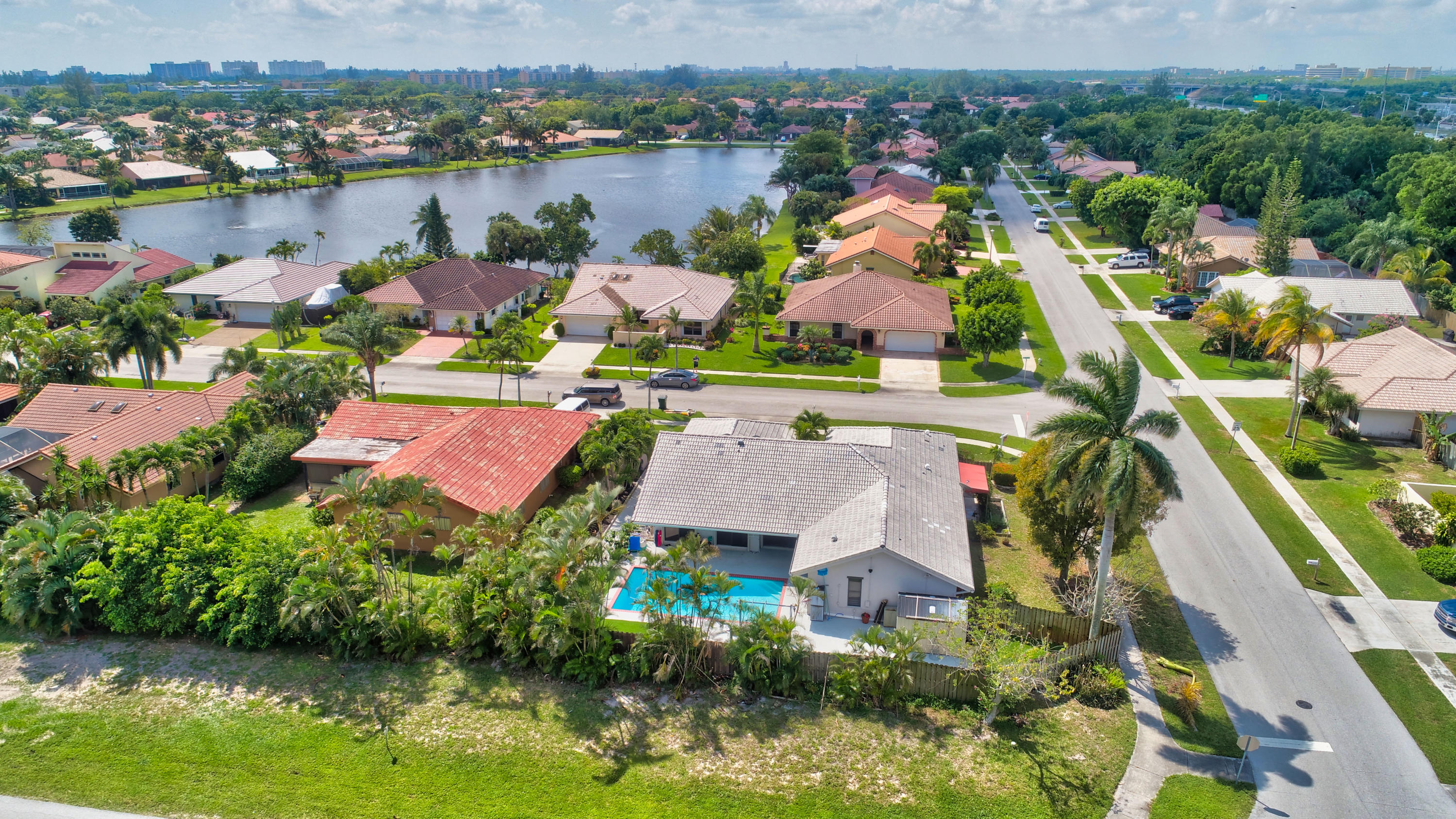 491 Northwest 72nd Street Boca Raton, FL 33487 - Photo 52 of 57 an aerial view of house with yard swimming pool and lake view