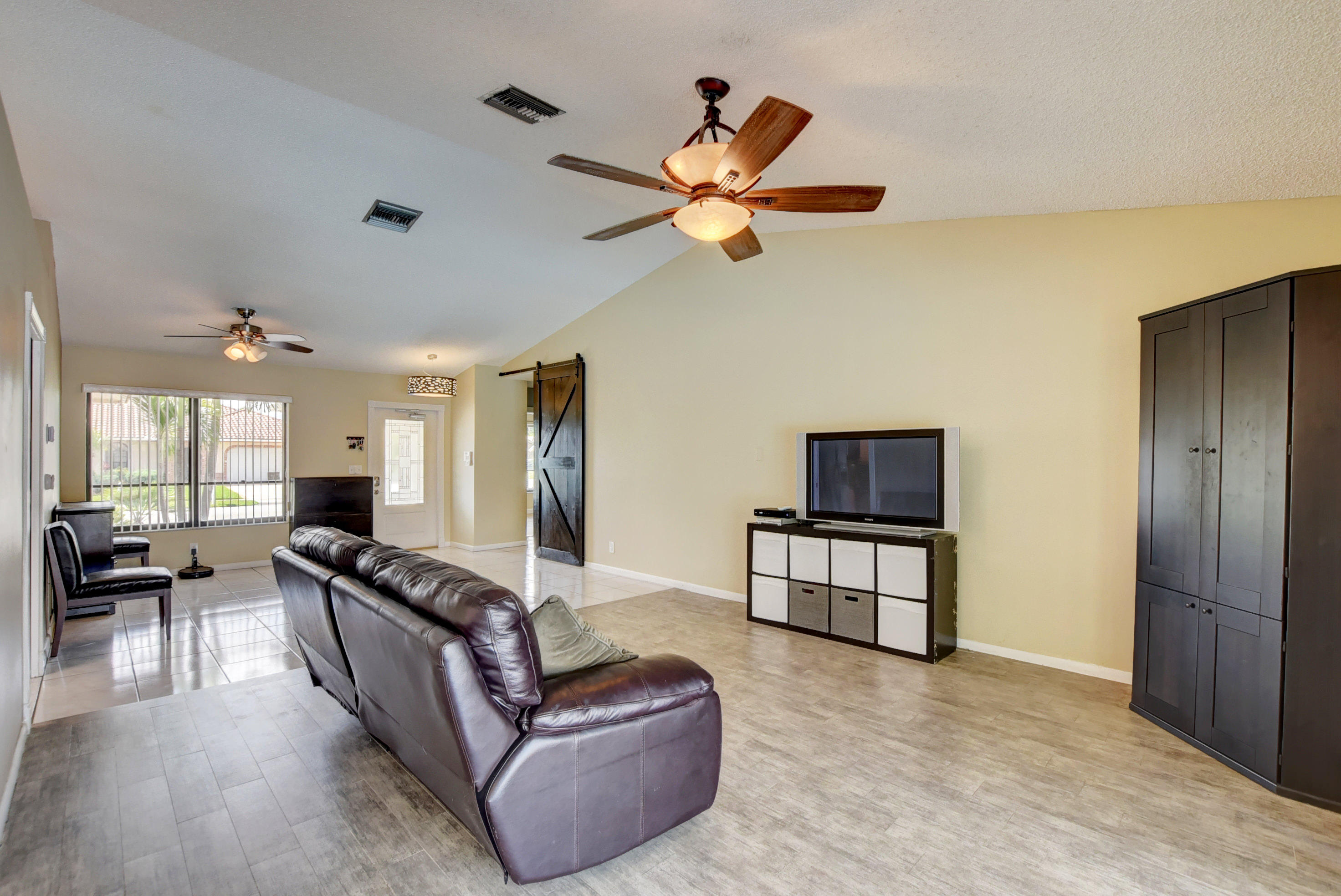 491 Northwest 72nd Street Boca Raton, FL 33487 - Photo 9 of 57 a living room with furniture and a wooden floor