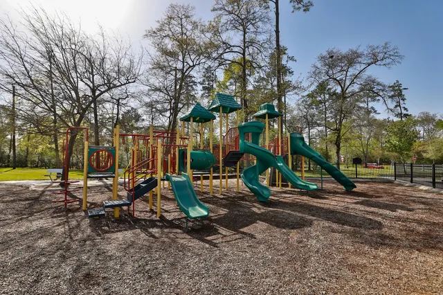 a view of a park with swings and slides