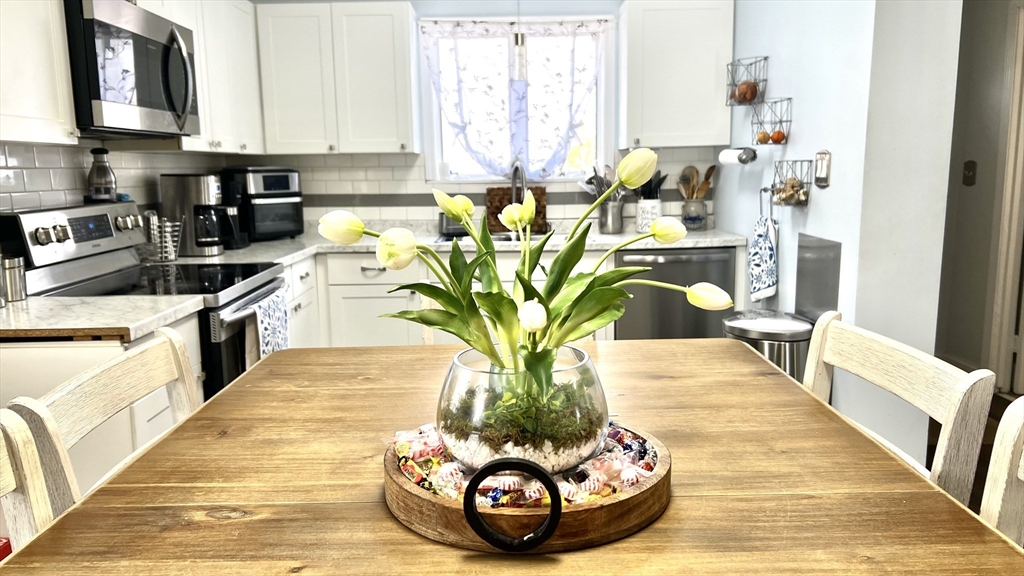 a view of a living room with furniture and a potted plant