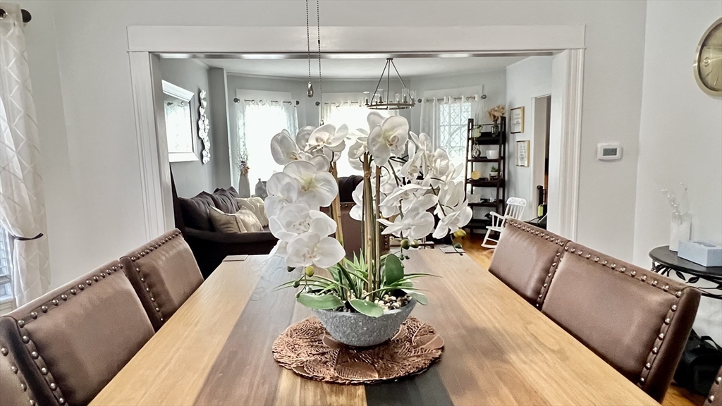 603 Temple Street Whitman, MA 02382 - Photo 11 of 40 a dining room with furniture and a chandelier