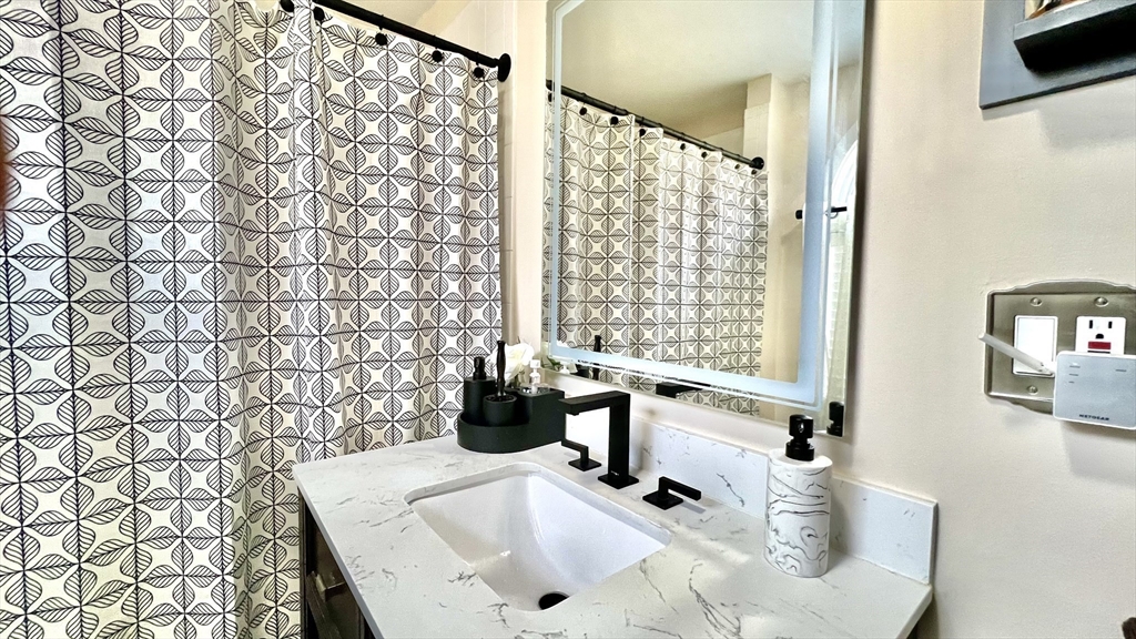 603 Temple Street Whitman, MA 02382 - Photo 14 of 40 a bathroom with a sink toilet and shower