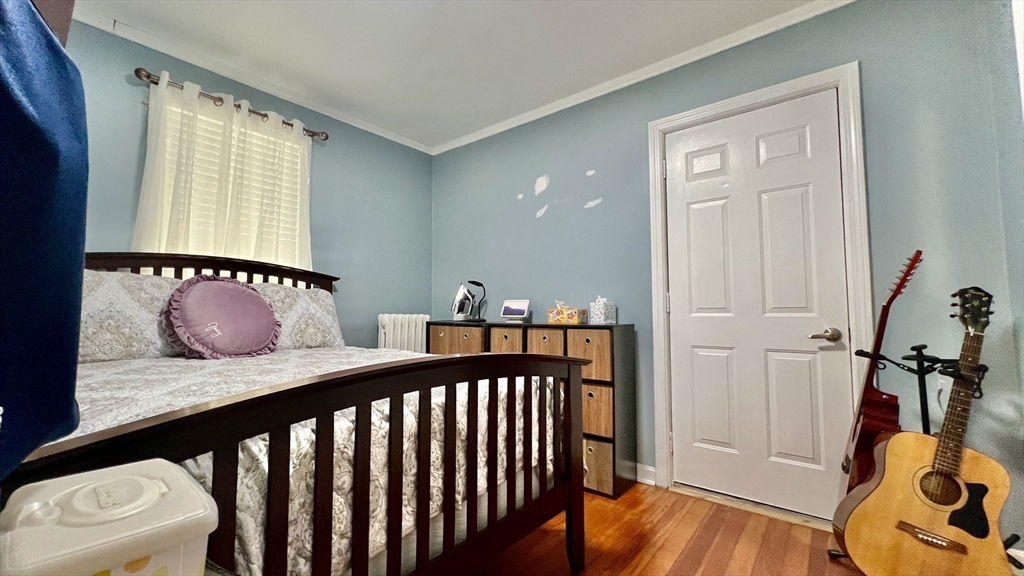 603 Temple Street Whitman, MA 02382 - Photo 17 of 40 a bedroom with a bed and wooden floor