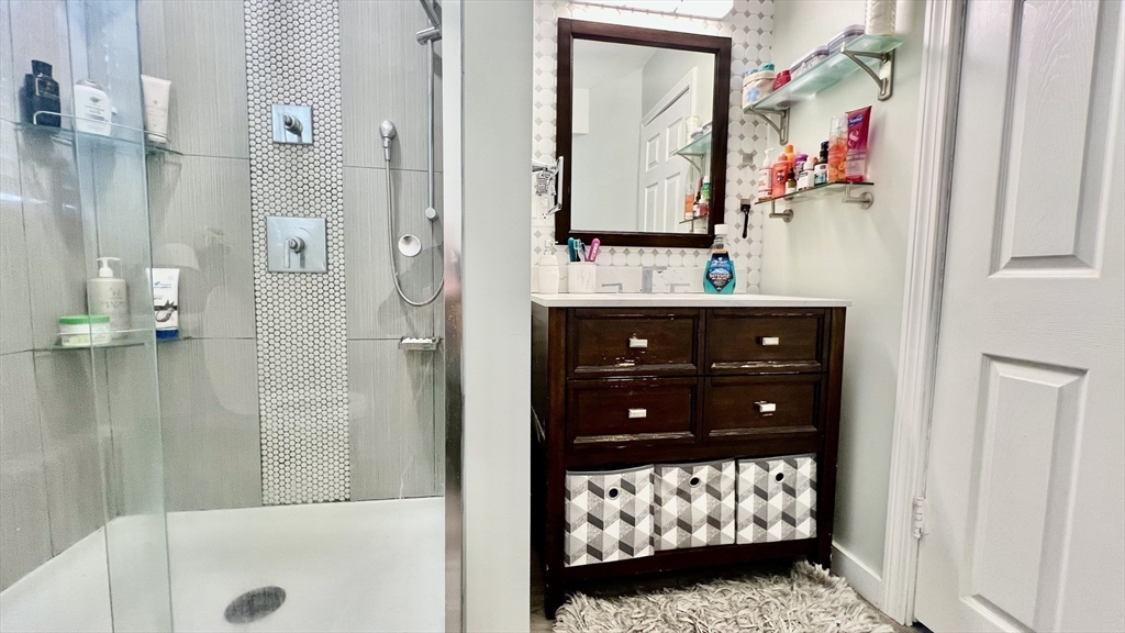 603 Temple Street Whitman, MA 02382 - Photo 21 of 40 a bathroom with a sink vanity and mirror