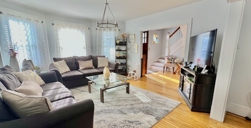 603 Temple Street Whitman, MA 02382 - Photo 9 of 40 a living room with furniture and a chandelier
