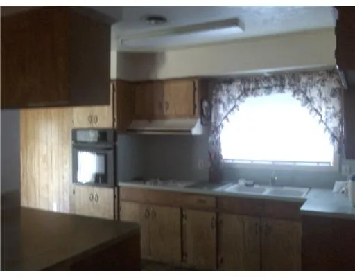 a view of wooden floor and windows in a room