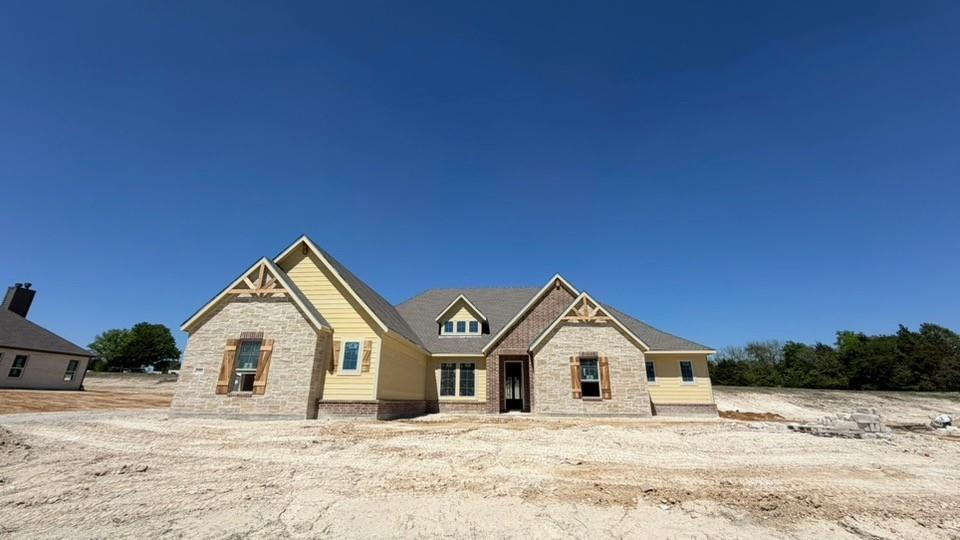 1002 Perrin Lane Van Alstyne, TX 75495 - Photo 2 of 9 a front of a house with a yard covered in snow