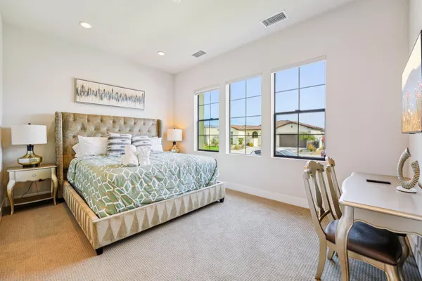 a bathroom with a toilet a sink a glass door a shower and a mirror