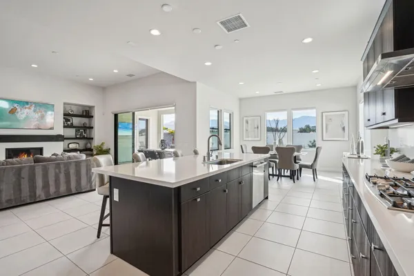 a kitchen with stainless steel appliances a sink a stove a counter top space and cabinets