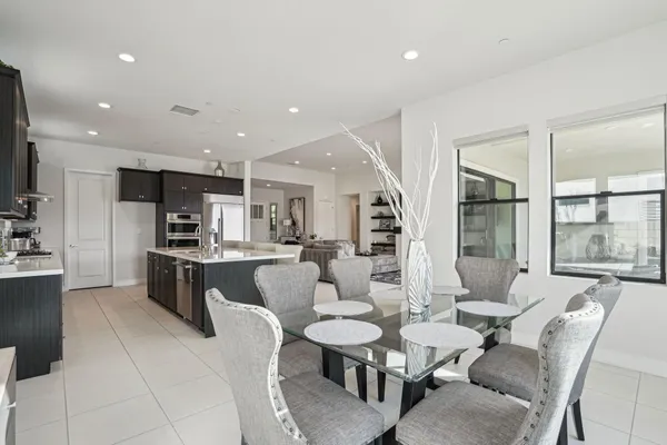 a large kitchen with a table and chairs