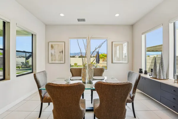 a view of a dining room with furniture and windows
