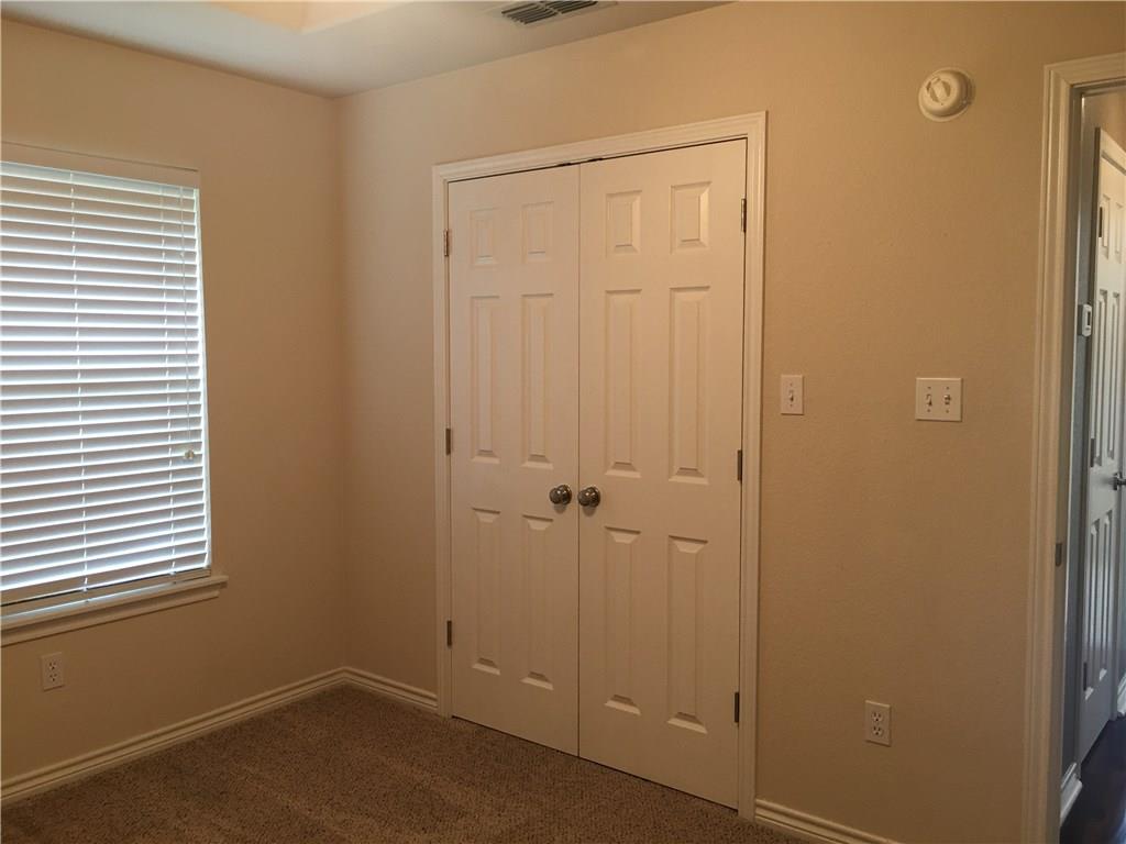2218 Old Ironsides Road Abilene, TX 79601 - Photo 14 of 26 an empty room with a wooden door