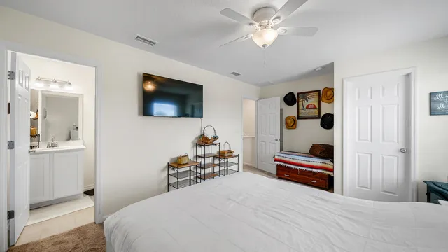 a bedroom with a bed and a flat screen tv