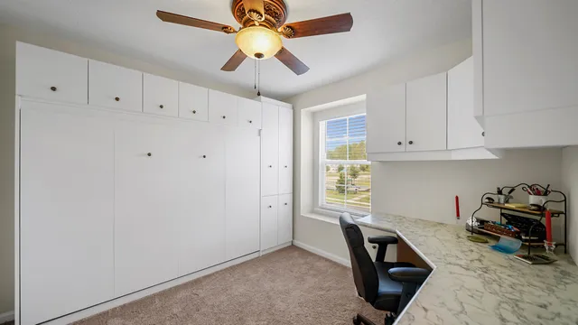 a kitchen with stainless steel appliances white cabinets and a refrigerator