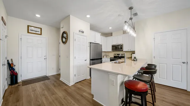 a kitchen with stainless steel appliances granite countertop a refrigerator and a stove top oven