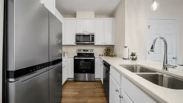 a kitchen with a sink cabinets and stainless steel appliances