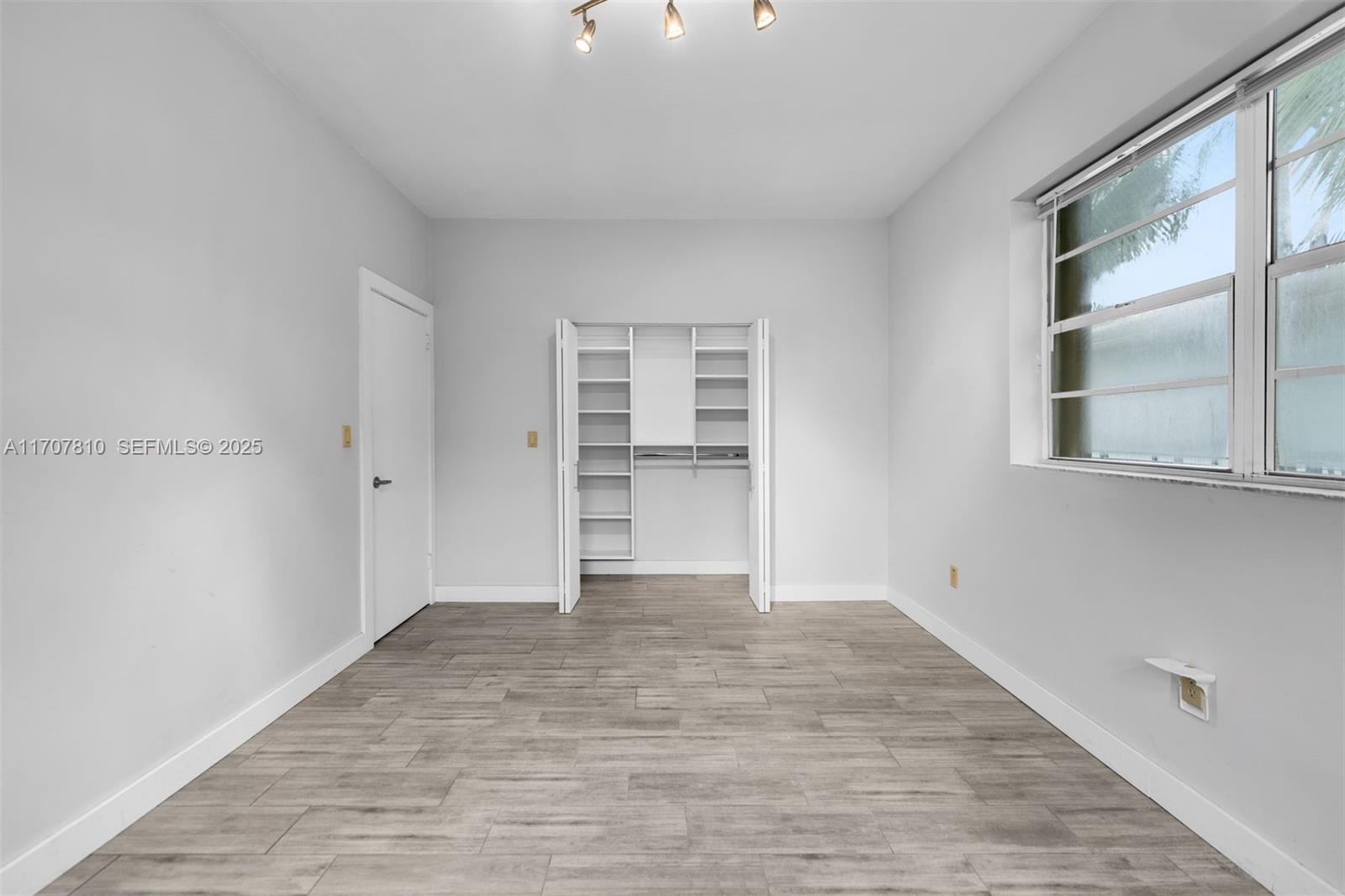 1622 Bay Road Miami Beach, FL 33139 - Photo 15 of 24 wooden floor in an empty room