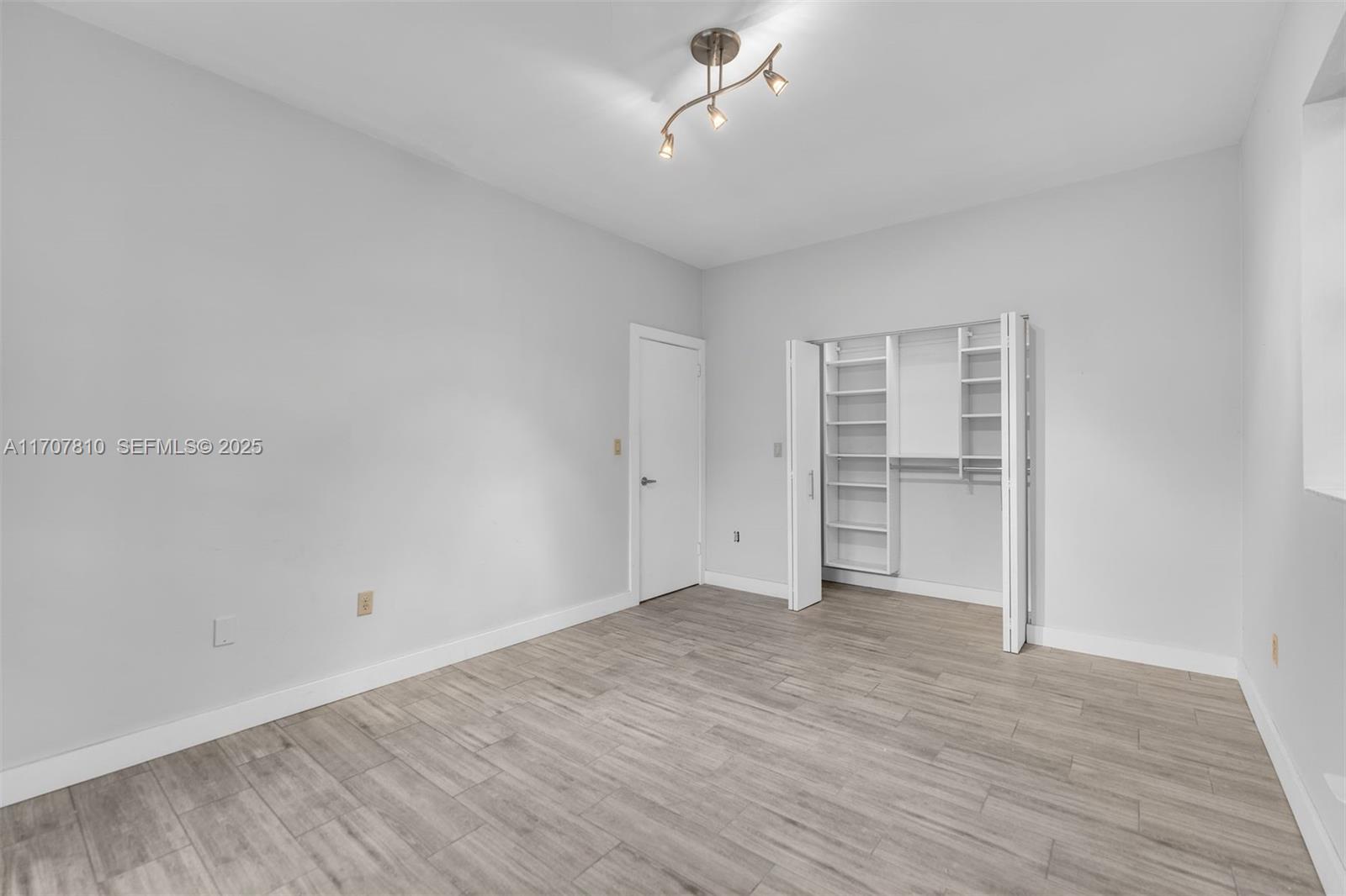 1622 Bay Road Miami Beach, FL 33139 - Photo 16 of 24 a view of empty room with wooden floor