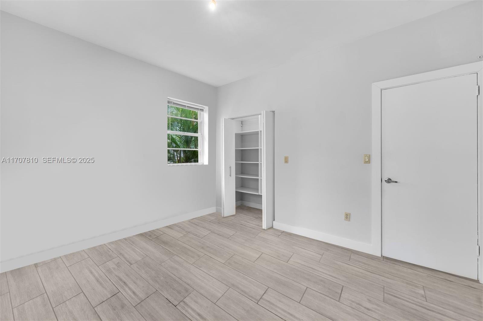 1622 Bay Road Miami Beach, FL 33139 - Photo 17 of 24 wooden floor in an empty room