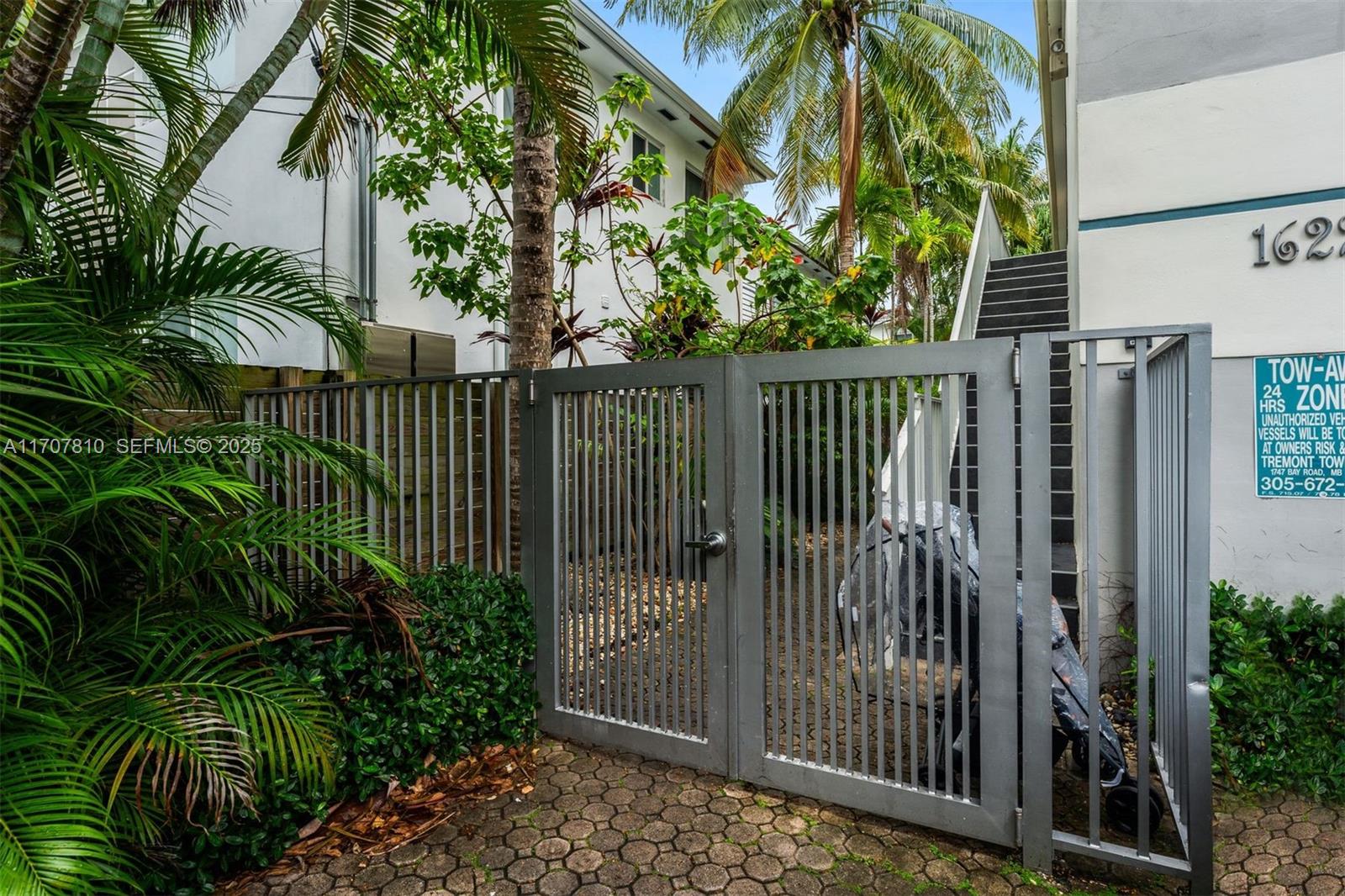 1622 Bay Road Miami Beach, FL 33139 - Photo 20 of 24 a view of a garden with a iron fence