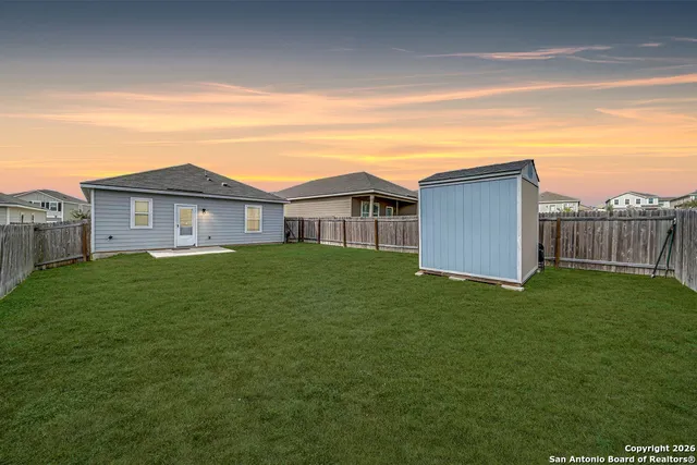 a view of a house with a backyard