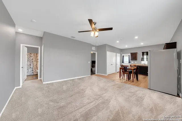 a view of a livingroom with furniture and a ceiling fan