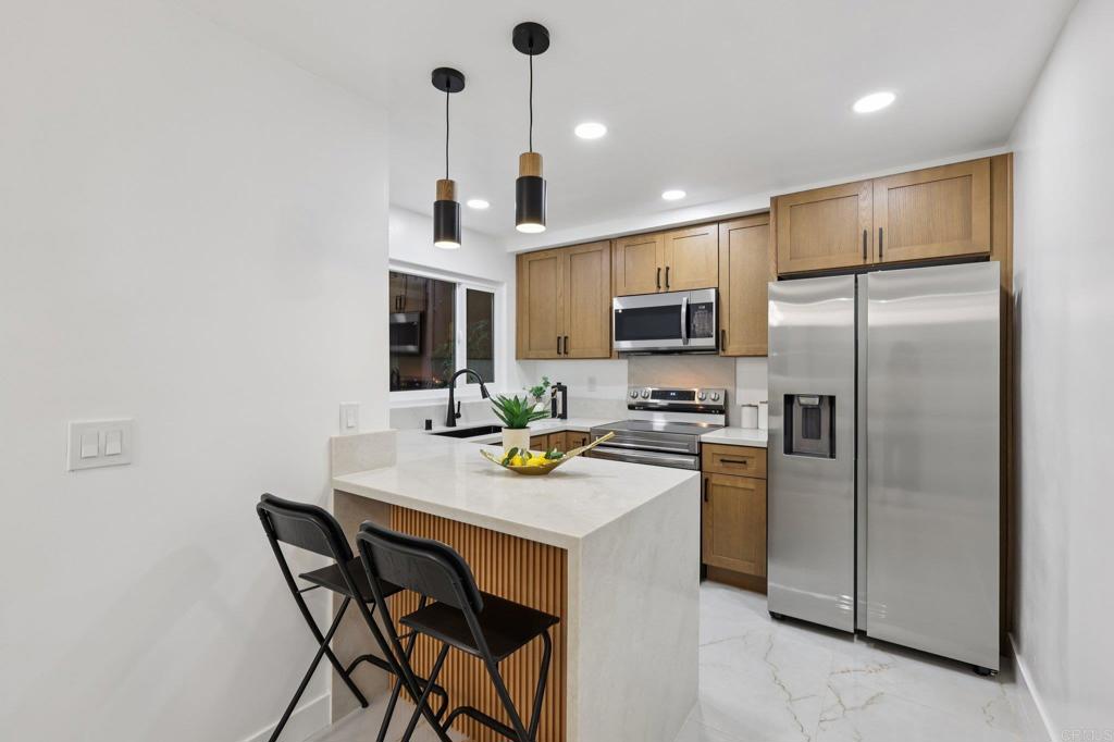 2600 Torrey Pines Road, Unit A13 La Jolla, CA 92037 - Photo 12 of 65 a kitchen with refrigerator cabinets and furniture