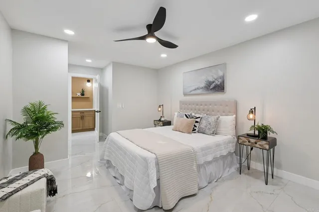 a view of a porch with chairs and potted plants