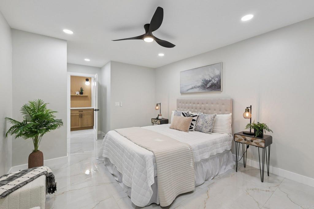 2600 Torrey Pines Road, Unit A13 La Jolla, CA 92037 - Photo 20 of 65 a bedroom with a large bed and a potted plant