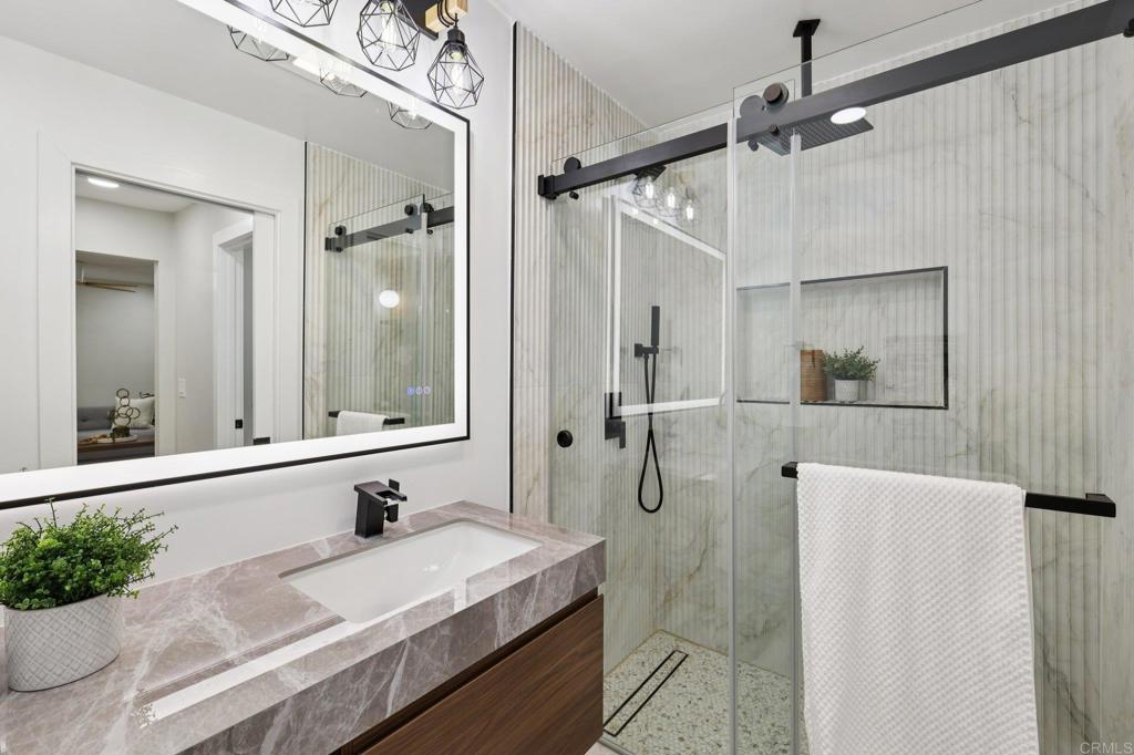 2600 Torrey Pines Road, Unit A13 La Jolla, CA 92037 - Photo 24 of 65 a bathroom with a granite countertop sink mirror and a shower