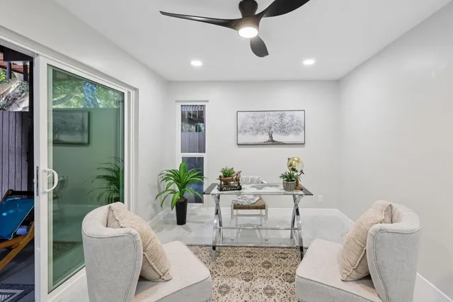 a living room with furniture and a potted plant