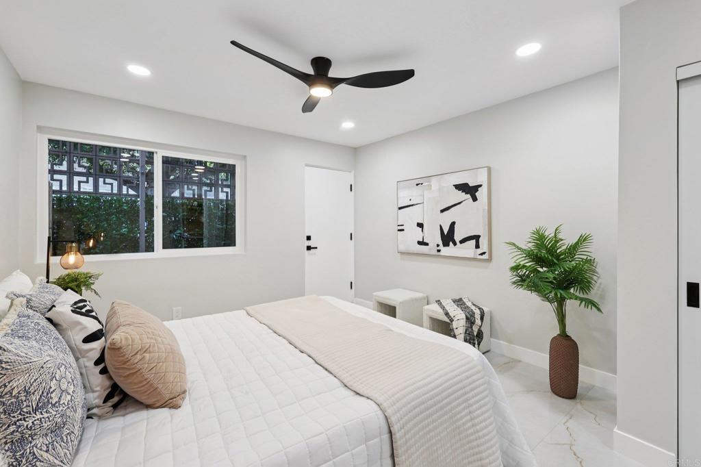 2600 Torrey Pines Road, Unit A13 La Jolla, CA 92037 - Photo 34 of 65 a bedroom with a large bed and a large window