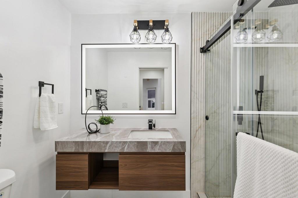 2600 Torrey Pines Road, Unit A13 La Jolla, CA 92037 - Photo 37 of 65 a bathroom with a sink and a mirror