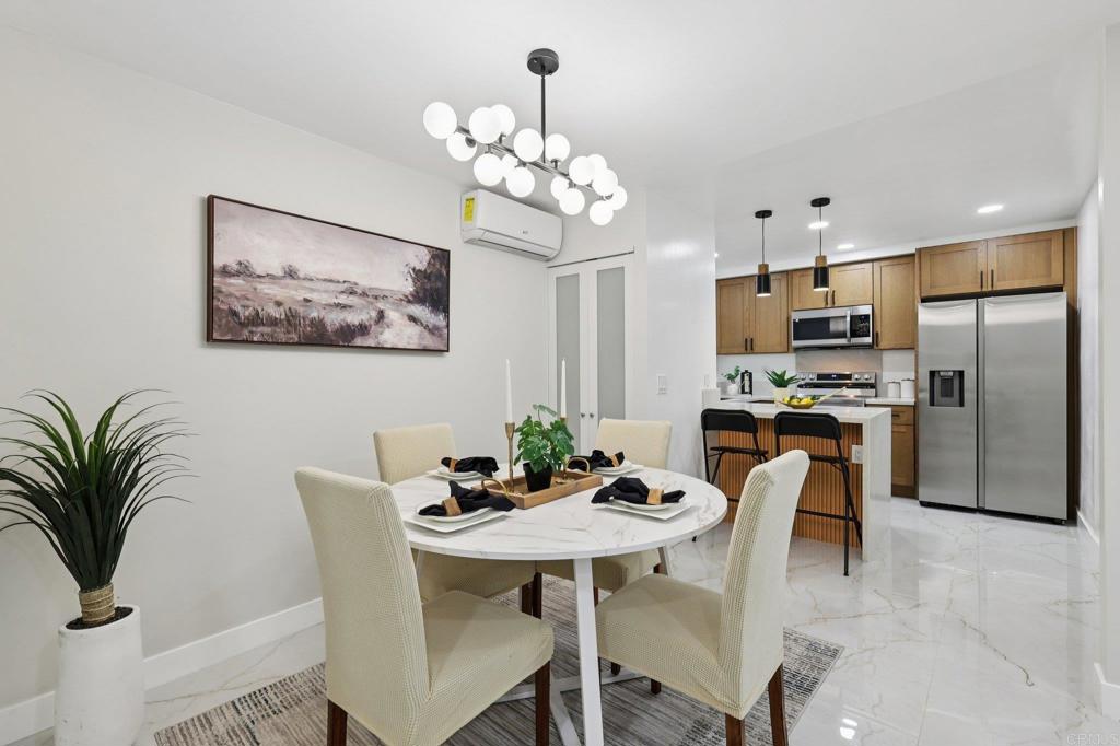 2600 Torrey Pines Road, Unit A13 La Jolla, CA 92037 - Photo 4 of 65 a view of a dining room with furniture a chandelier and wooden floor
