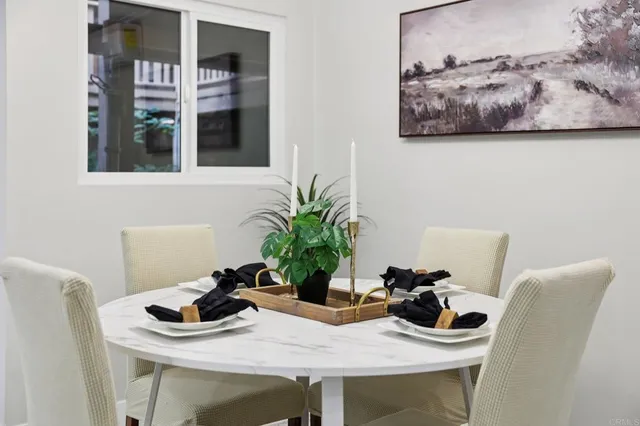a view of a dining room with furniture and chandelier