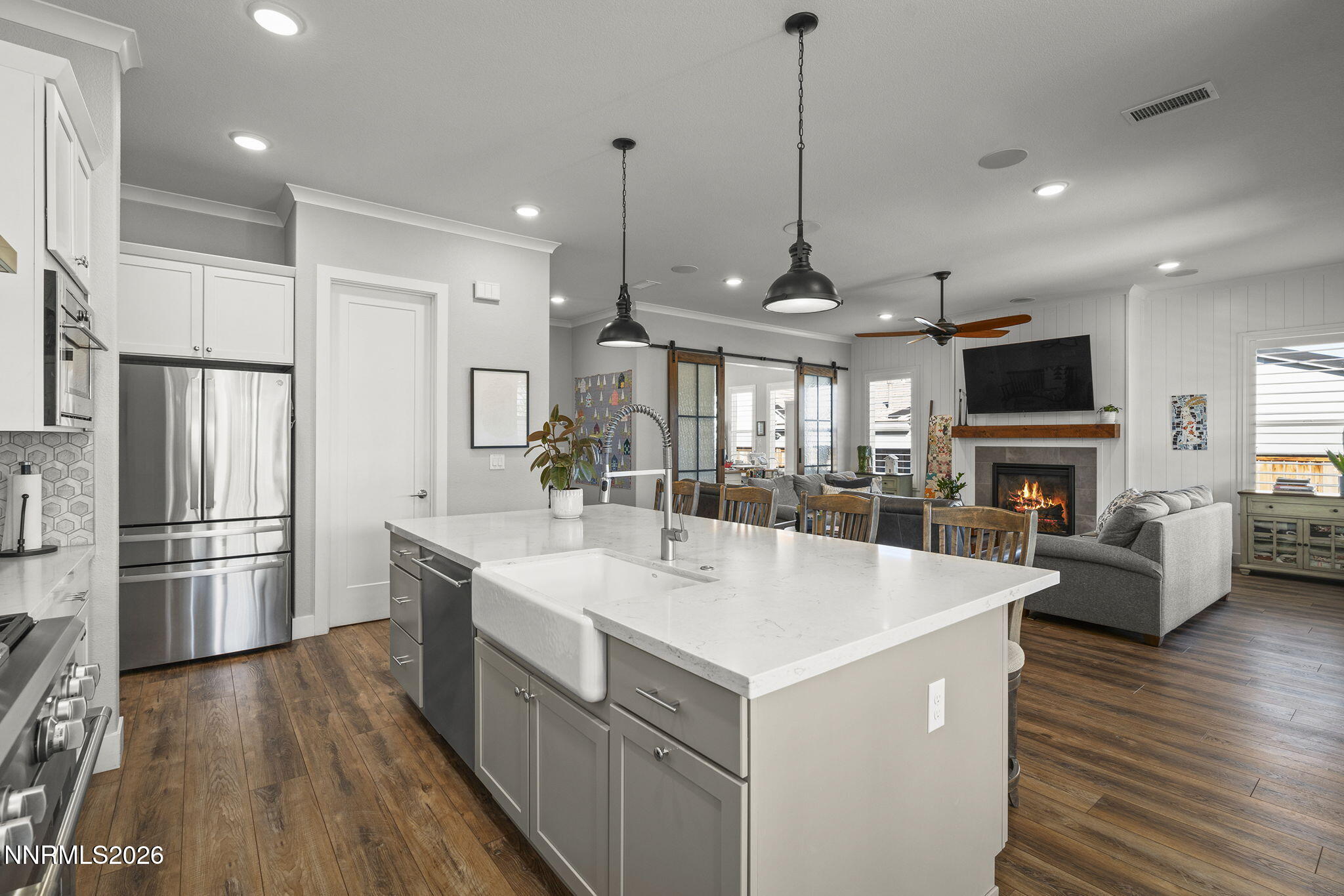 8726 Larkhaven Court Reno, NV 89523 - Photo 13 of 41 a large kitchen with kitchen island a stove a sink a center island a refrigerator and a wooden floor
