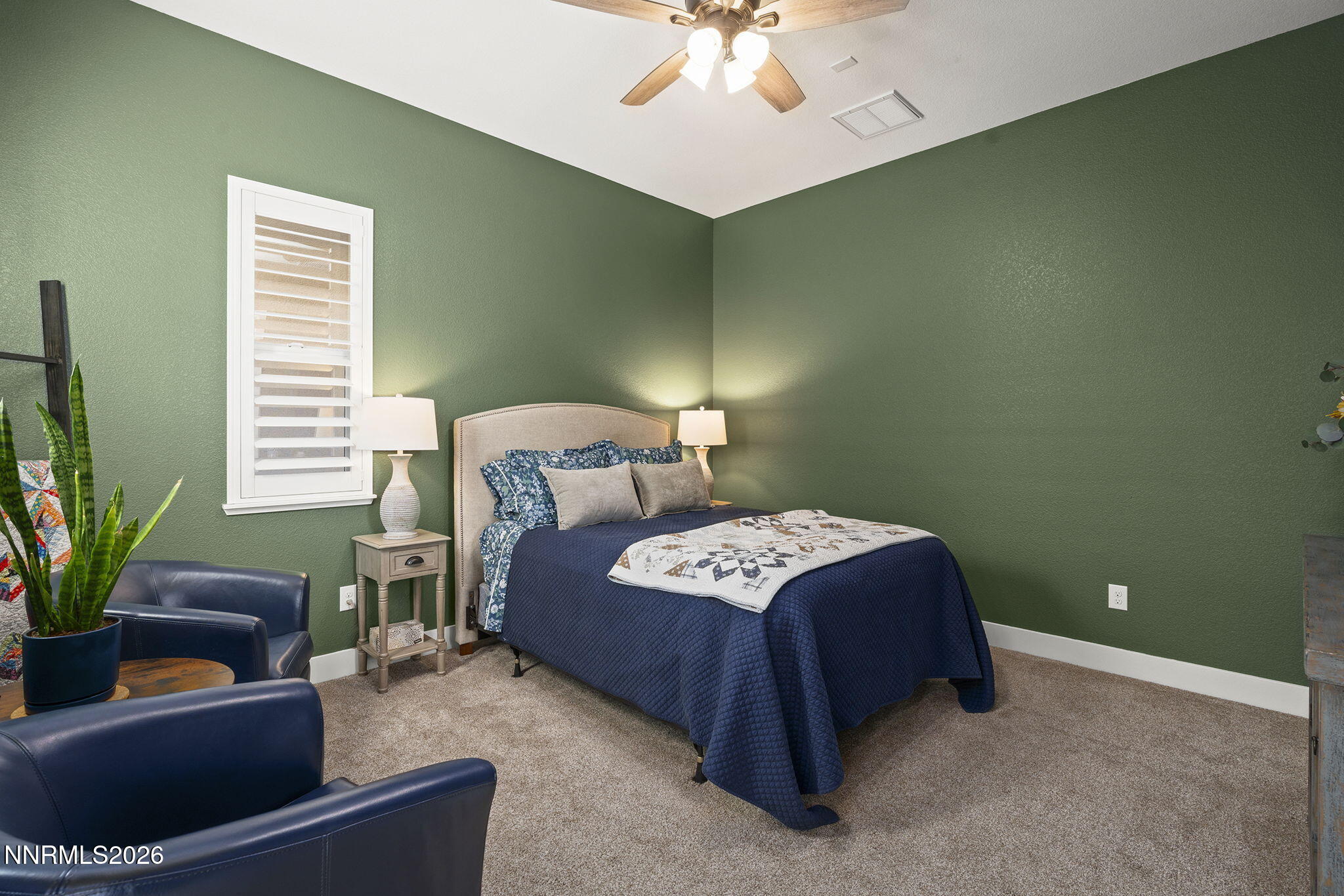 8726 Larkhaven Court Reno, NV 89523 - Photo 28 of 41 a bedroom with a bed and a potted plant