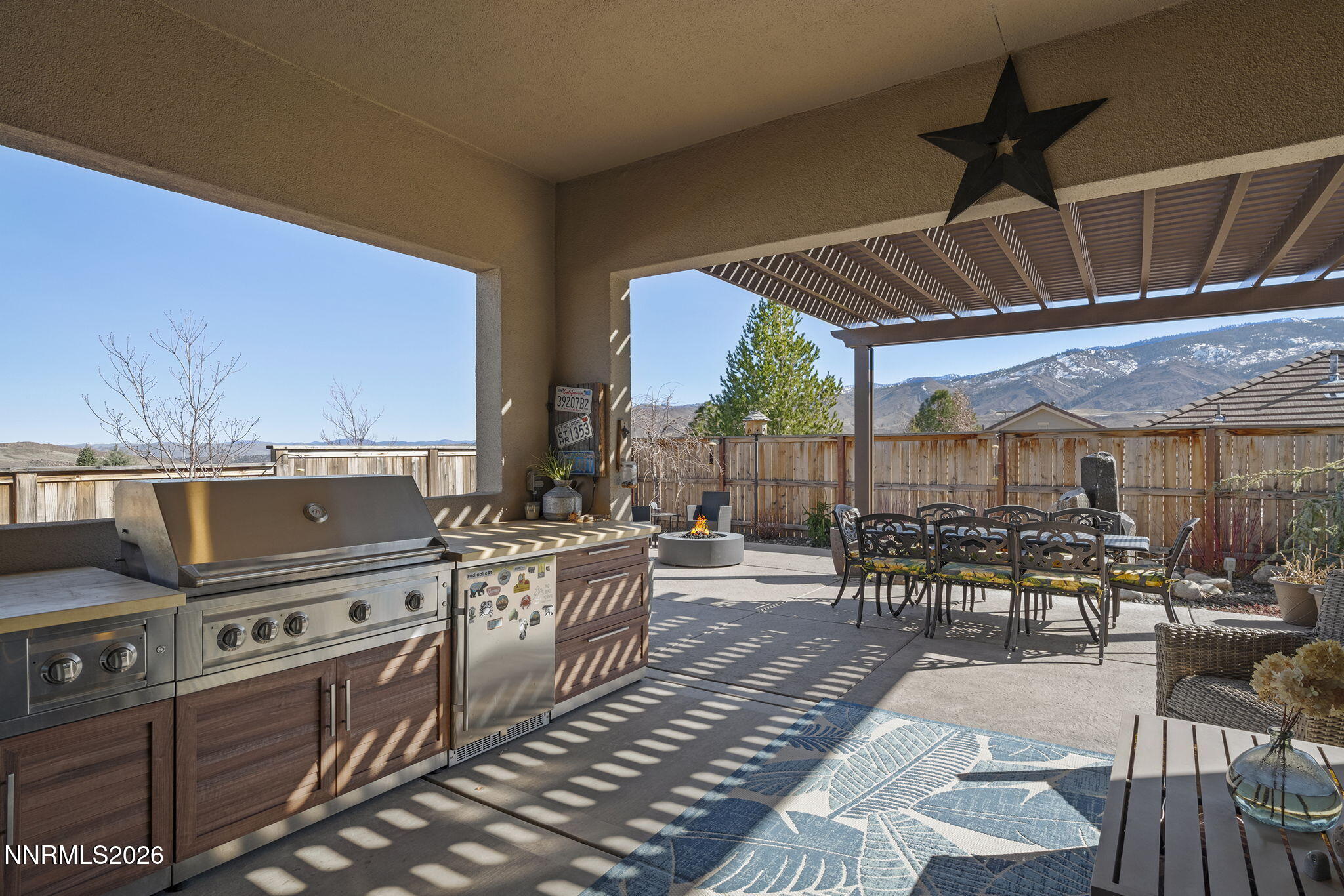 8726 Larkhaven Court Reno, NV 89523 - Photo 31 of 41 a view of a patio with table and chairs a barbeque