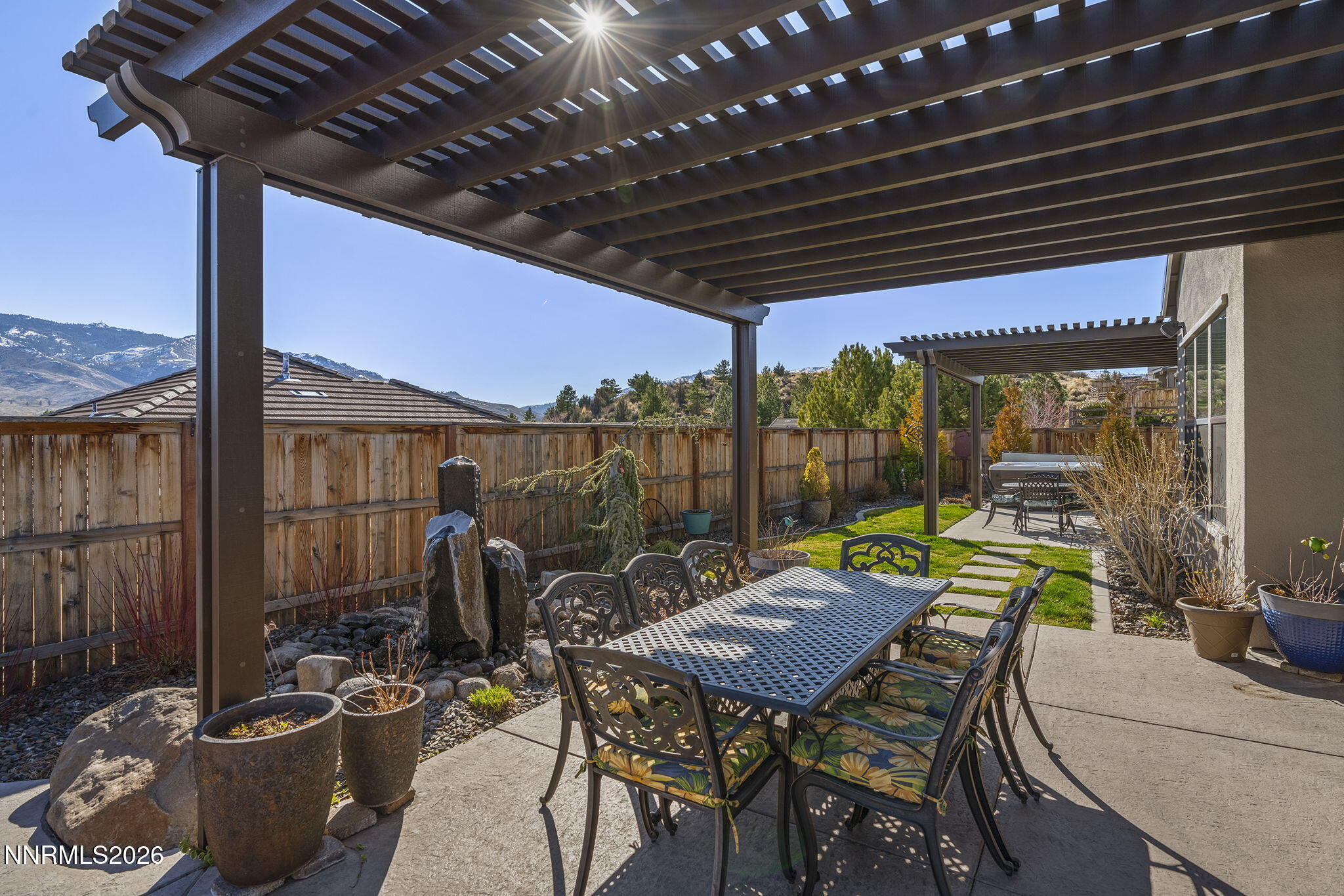 8726 Larkhaven Court Reno, NV 89523 - Photo 35 of 41 a view of a patio with a table and chairs and potted plants
