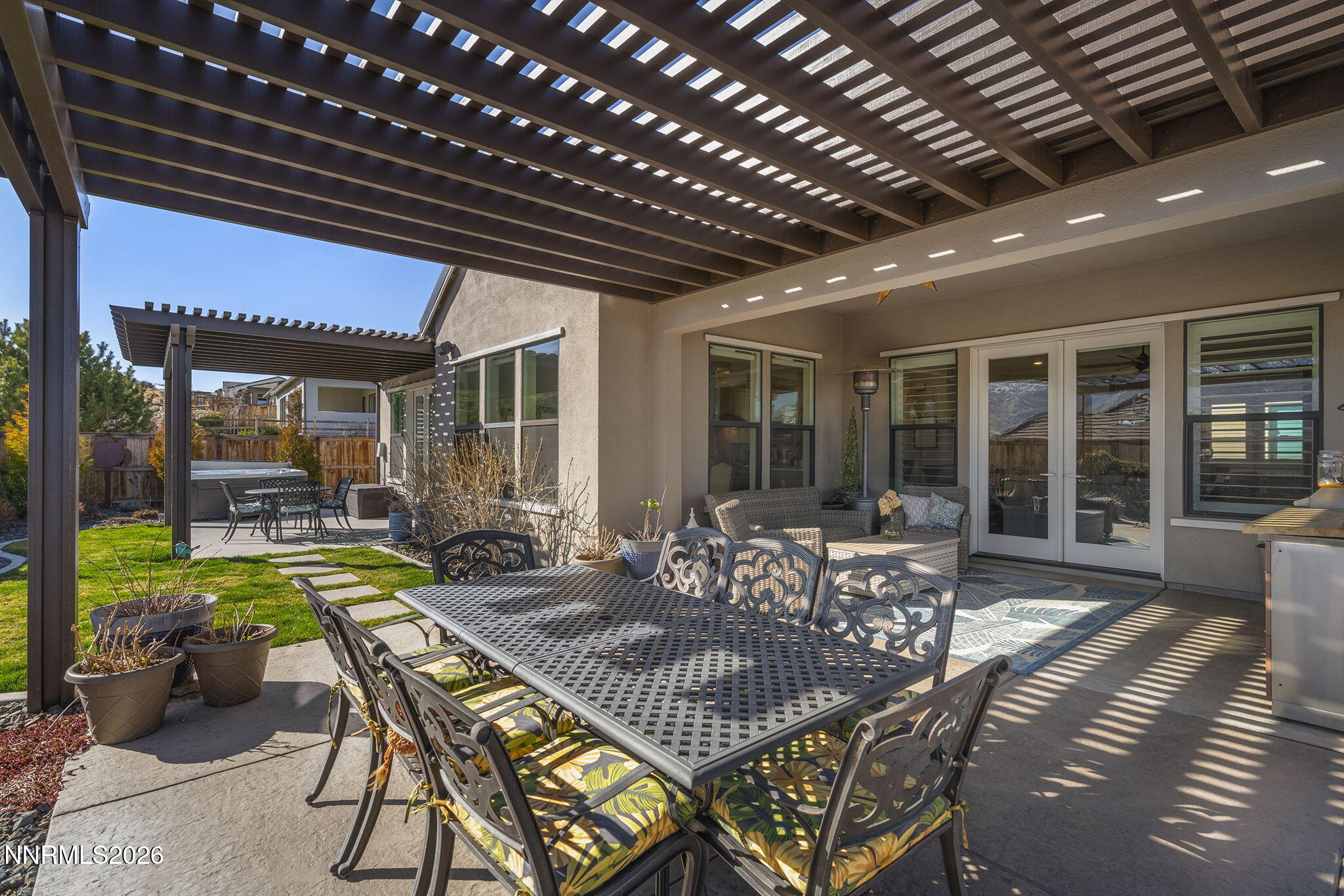 8726 Larkhaven Court Reno, NV 89523 - Photo 36 of 41 a view of a patio with table and chairs potted plants with floor to ceiling window and potted plants