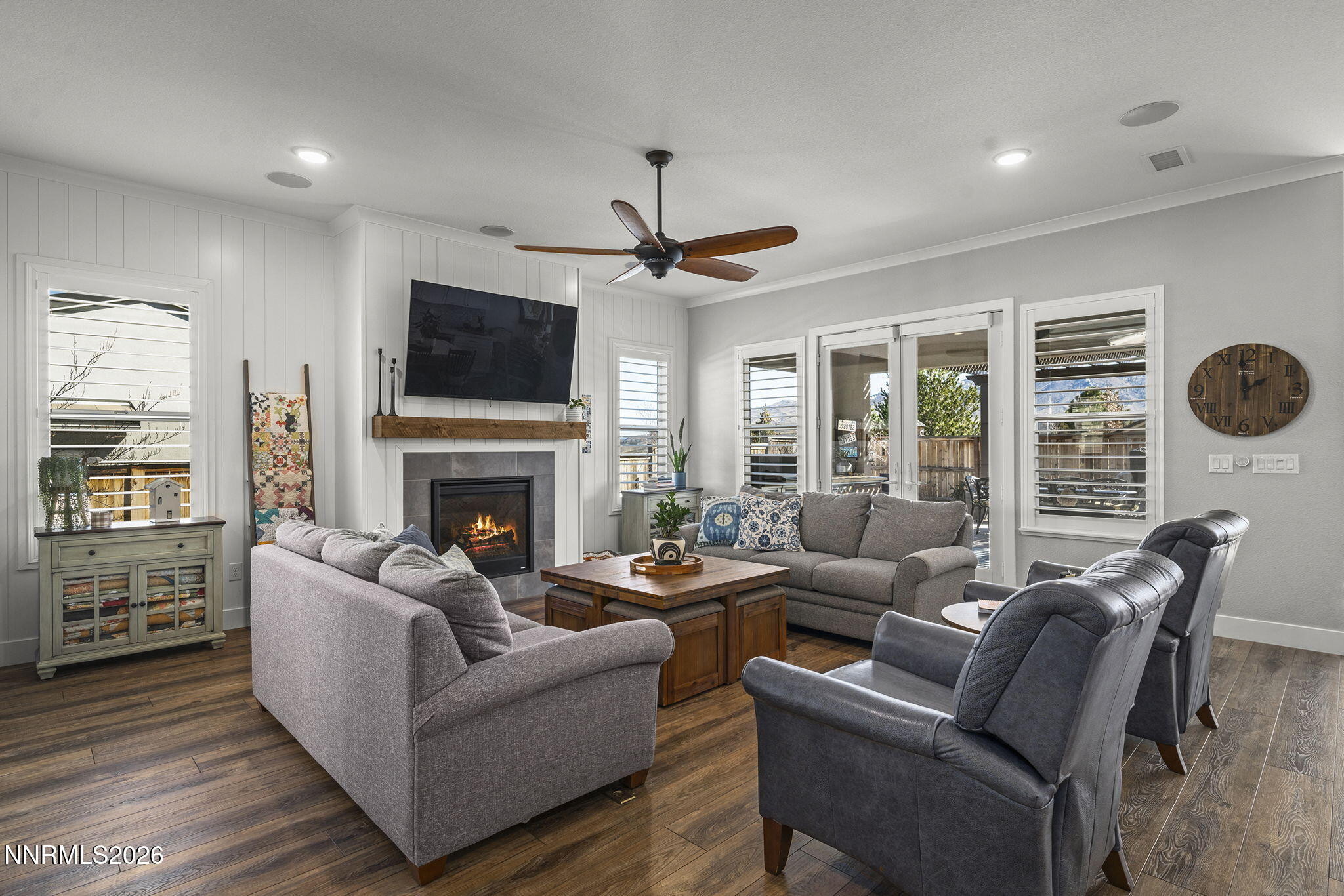 8726 Larkhaven Court Reno, NV 89523 - Photo 5 of 41 a living room with furniture a flat screen tv and a fireplace